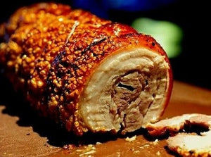 Rotisserie Whole Porchetta. Flame Show Cooking Catering or Drop Off Catering